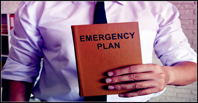 a brown notebook entitled "Emergency Plan" is held by a white man in business attire